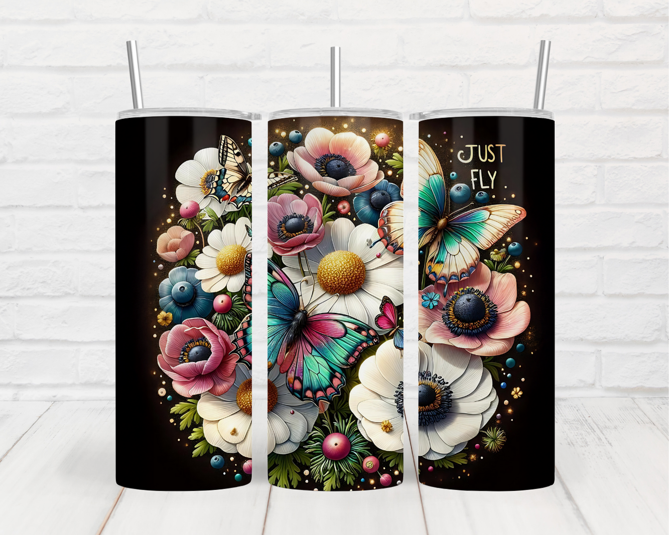 a couple of black tumbles with flowers and butterflies on them