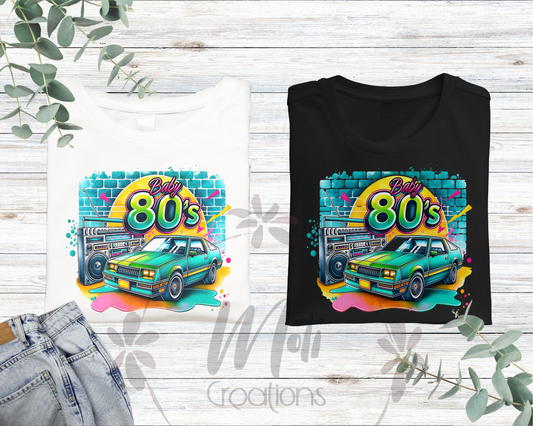 a couple of t - shirts sitting on top of a wooden table